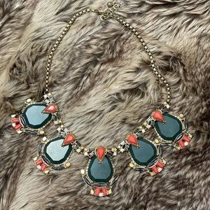 Gold statement necklace with green jewels